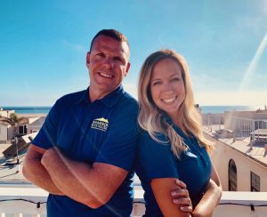 Shannon posing with her husband wearing blue tshirts